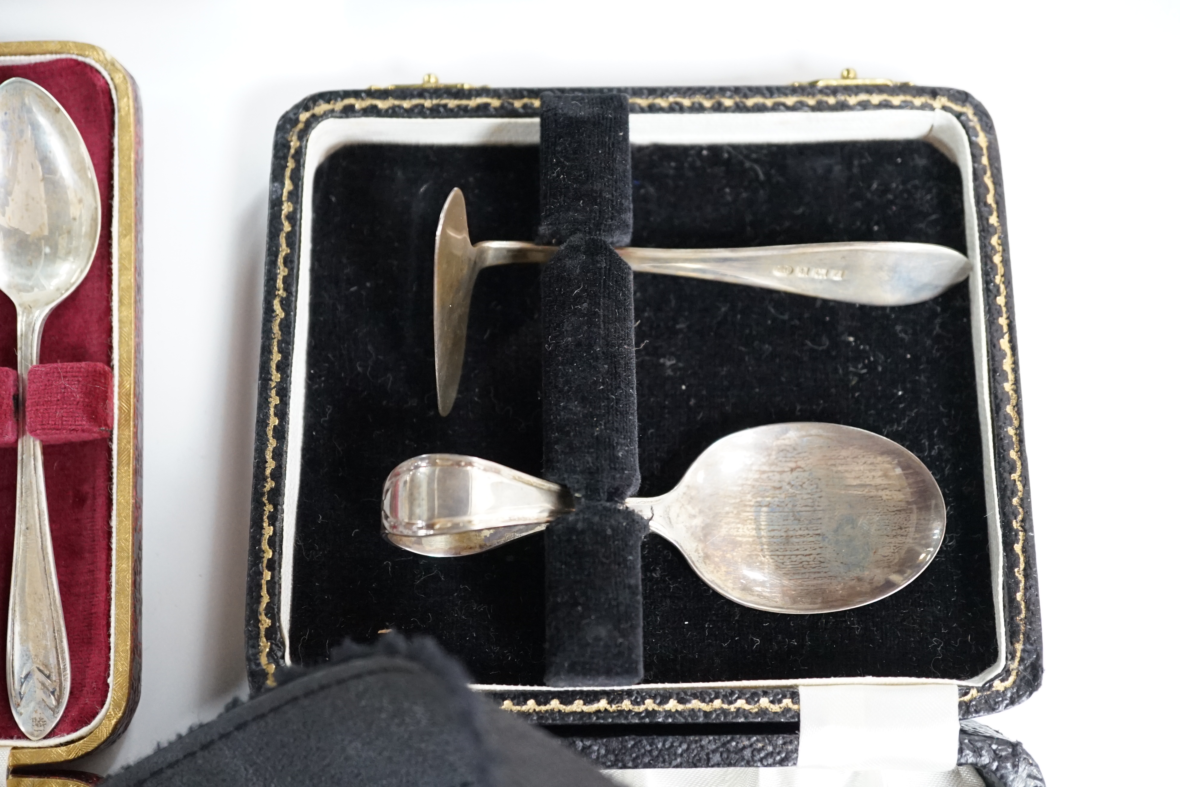 A cased set of six mid 20th century silver teaspoons, a cased silver spoon and pusher, two cased silver christening sets, a boxed silver spoon and one other incomplete cased set. Condition - poor to fair